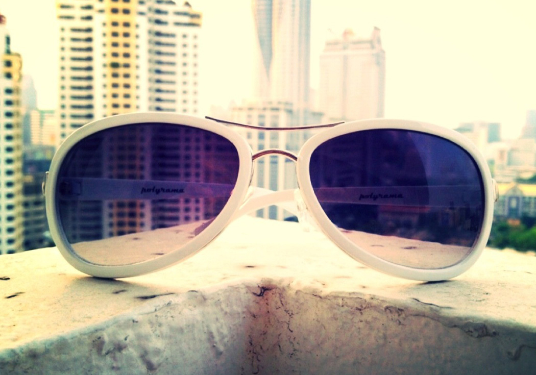 Polyrama aviator composite sunglasses on cement wall